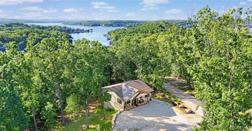 Great location for this adorable home.  Home has 5 bedrooms and 5 bathrooms, making it perfect for full time residence, 2nd home, or Air BnB.  Two newly constructed decks offer expansive room for entertaining and a seasonal view of the Lake. Electric fireplace in the living area adds a warm atmosphere to any season. The Shawnee Bend Access and Boat launch ramp is located just 1/4 mile on Hwy TT, or a boat slip is available for lease, located just 6/10 mile down the road. Lot next door is available if wanting to purchase for additional green space or area to build a shop or garage.  Only 9 miles to Lake Ozark, via Community Bridge, and 9 miles to town of Laurie.