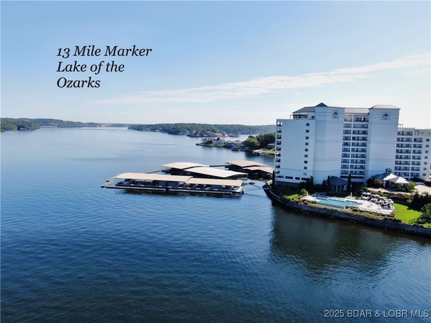 Enjoy upscale luxury lakeside living at Cypress at the Lake on the 13MM of the Lake of the Ozarks. This 4th-floor condo offers incredible east-facing views from the covered deck of the main channel that stretches for miles. This unit features an open floor plan, updated kitchen, dining area, living room with a fireplace, includes 3 bedrooms, 2 Bedrooms with en-suites, and 3 total bathrooms. This luxury unit comes fully furnished—ready for you to move in and enjoy. A 12x36 boat slip on Community Dock A is included, complete with upgraded 30-amp electrical service. Cypress at the Lake is known for its exquisite amenities, including elevators with zero-step entry, a heated infinity saltwater pool maintained at 86 degrees, a gas fire pit with remote start, a fully equipped fitness center, two levels of assigned garage parking, a fenced dog park, community gas and charcoal grills, and steel concrete construction for quiet living. The on-site staff provide a welcoming and helpful atmosphere. Conveniently located just minutes from popular lake destinations such as Paradise Bar & Grill, Lake House 13, JB Hooks, Baxter's, and the historic Bagnell Dam Strip.