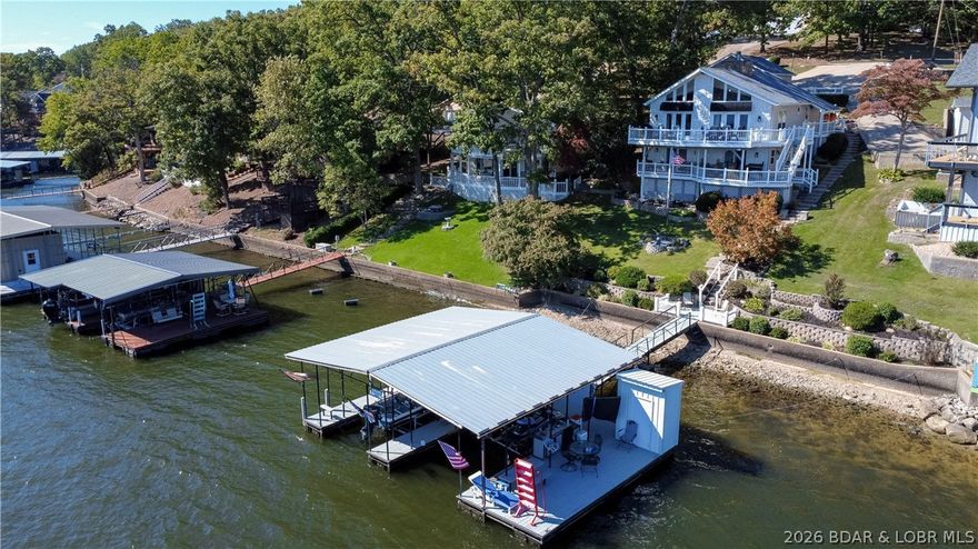 What an amazing lakefront view....and the house is pretty great too. Lakefront living at its best. Over 2400 sqft
of living space, windows galore to soak up that view, 2 car garage, dock and close to amenities of town. Also
close to Ozark Amphitheatre, and several lakefront restaurants (by boat and land). Lots of deck space to enjoy
your outside activities. Easy lakefront slope and only a few steps to get to your dock. Do not miss your
opportunity to call this 3 bed 2.5 bath, remodeled home, yours. Would make a great full time occupy, 2nd home
or nightly rental.