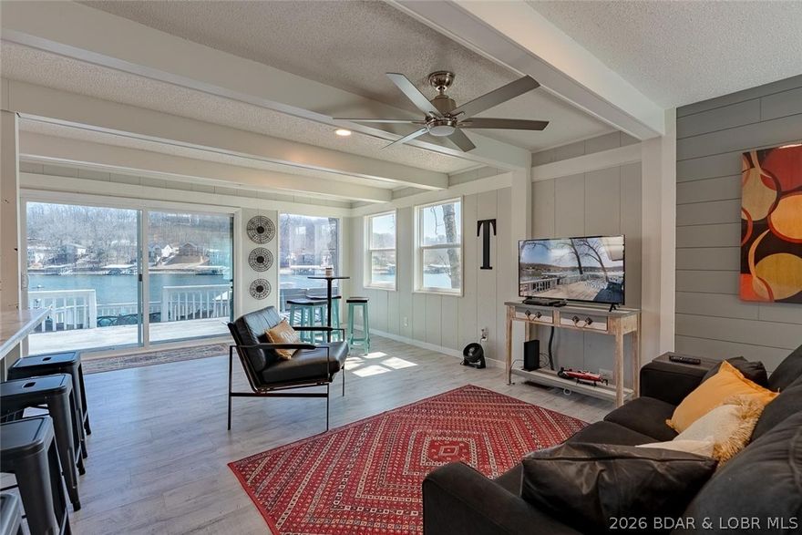 Charming and fully updated 2-bedroom, 1-bath lakefront retreat at the Lake of the Ozarks! Boasting 126 feet of shoreline in a fantastic cove at the 8MM, this property offers the perfect blend of peaceful lake living and easy access to all the action. Enjoy outdoor living at its best with a spacious two-tier deck ideal for entertaining or relaxing. The large dock features two generous boat slips, two personal watercraft slips, plus a concrete swim platform with a high dive—perfect for endless lake fun. Tucked away on the quiet side of the lake, yet just minutes from popular waterfront destinations, this home delivers the best of both worlds. Even better, it includes your own private boat ramp for ultimate convenience. Whether you're looking for a weekend getaway or for an investment rental property, this home checks all the boxes! Schedule your appt today to see this one, it won't last long!