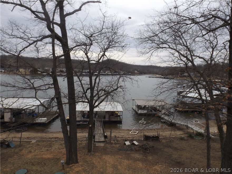 Experience lakefront living in this stunning modern home featuring 61 feet of waterfront and breathtaking views. Designed with an open-concept layout, this 3-bedroom, 3-bathroom residence is filled with natural light from expansive windows that seamlessly blend indoor and outdoor living.  The spacious main living area flows effortlessly into a beautifully appointed kitchen complete with custom cabinets, sleek finishes, and luxury vinyl plank flooring throughout. Step outside to the deck—perfect for entertaining, relaxing, or enjoying peaceful sunsets over the water.  Ideally located near vibrant nightlife, top-rated restaurants, and entertainment, this home offers the perfect balance of tranquil waterfront living and convenient access to everything you love.  A rare opportunity to own a modern lakefront retreat with style, comfort, and unbeatable views.