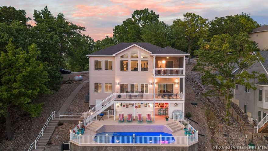 Experience luxury lakefront living at the 31 Mile Marker in Linn Creek, MO. This beautifully updated 5-bedroom, 3 full bath, and 2 half bath home offers the perfect blend of comfort and modern convenience. The home has been extensively renovated, featuring all-new appliances (just 1-2 years old), a stunning kitchen with new cabinetry and pull-out drawers, and a dual-fuel range. Generac system installed, which completely services the first floor of the home. Super screens are in the screened in deck off the kitchen. The open living space is designed for both relaxation and entertaining, complete with a propane fireplace, automatic blinds, tinted windows, and upgraded super screens. Laundry room on both levels. Step outside to enjoy low-maintenance concrete decks with durable powder-coated railings. The home is also wired for surround sound. The spacious master suite features a walk-in shower and walk-in closet, and soaking tub while main-level living adds everyday convenience. Additional updates include a roof replacement just 2 years ago, Windows have been tinted only one year ago. Heated private pool with waterfalls. Covered built in custom bar area with its own bathroom.