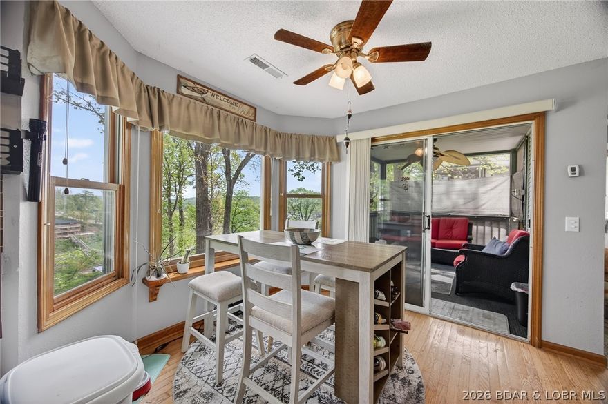 Experience the perfect blend of accessibility & quiet lakeside luxury in this stunning walk-in level unit. Located at the 4-mile marker, this 3 bedroom, 2 bathroom condo offers a peaceful retreat from the hustle & bustle, nestled within a community known for its mature dogwoods, manicured grounds and a true sense of neighborhood. Step inside to an expansive, open-concept living space where natural light pours through large windows. The living space extends seamlessly outdoors, offering 2 distinct areas to breathe in the fresh lake air: Oversized Screened Deck accessible from the master suite, providing a private haven for morning coffee. A second screened porch located off the dining area, ideal for al fresco meals while watching the light dance on the cove. A 10x24 boat slip w/ hoist located in a protected, calm-water cove. Forget the stairs—this unit is just two steps from your parking spot making grocery hauls a breeze. Located just off HH, you are mins from the best dining & shopping at the Lake, yet worlds away in a quiet cove. With strict rental restrictions, Steeple Ridge remains a tranquil environment ensuring your neighbors are familiar faces rather than weekend tourists.
