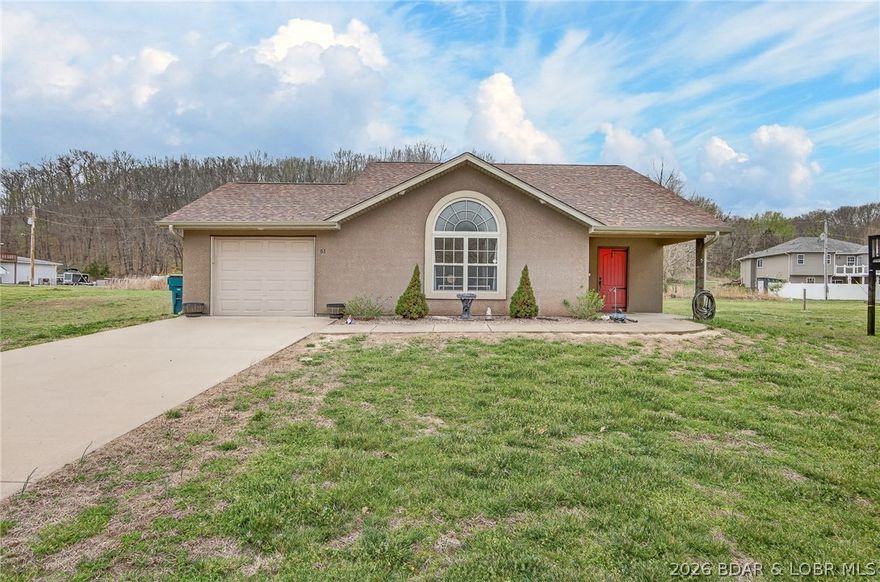 Rare opportunity to own a level lot with a flat driveway and fenced backyard in the highly desirable Camelot Estates. This well-maintained 3-bedroom, 2-bath residence offers true single-level living within a premier lake-access community. Recent exterior improvements include a new roof, gutters, downspouts, and partial siding replacement following October 2025 hail damage. The home showcases attractive stucco accents complemented by low-maintenance vinyl siding and is ideally positioned near the center of the community for convenient access to amenities, including two boat ramps, swimming pools, clubhouse, pickleball courts, equestrian facilities, an enclosed fishing dock, and boat slip rental/purchase options. Interior features include tall-vaulted ceilings, recessed lighting, and tile flooring throughout the entry, kitchen, and baths. The kitchen is equipped with updated stainless-steel appliances and a glass tile backsplash. The guest bath offers dual vanities with granite countertops, while the private primary suite features an updated en-suite bath. An excellent opportunity for low-maintenance lake living. Stop by an take a look at 51 Arthur Dr today!