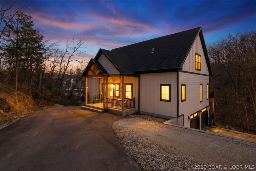 Experience the best of lakefront living at the 1-mile marker in the heart of Lake Ozark. This custom built 4-Bedroom, 4-Bath home, completed in 2024 offers approximately 3,325 Sq Ft of thoughtfully designed living space and an impressive 263' of lake frontage in a prime location. The Kitchen is a true gem featuring Quartz countertops, double wall ovens, and an expansive walk-in pantry. Flowing seamlessly into the main living area, you'll find soaring vaulted ceilings that create a grand feel with tons of natural light. You will love the cove protected waters, exceptional privacy, and unbeatable convenience - Just minutes by water or land to popular waterfront destinations and the iconic Bagnell Dam Strip. Designed for both entertaining and everyday comfort, this newer construction home combines modern finishes with the relaxed luxury of lake life. No HOA restrictions provides flexibility for full-time living, a second home getaway, or investment potential. Rarely does a newer custom lakefront home with this much frontage and this central location come available - Schedule your private showing today!