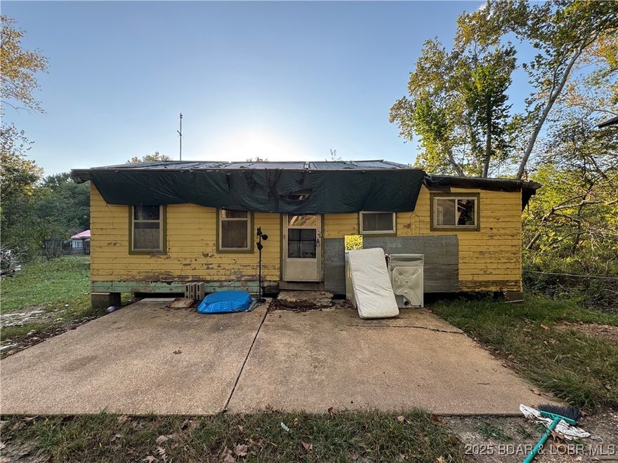 Investors and DIYers, this one is for you! Priced at only $35k! Seller has replaced electrical, plumbing, water heater, and started on the drywall and bathroom remodel. Selling in as-is condition. Just a walk away from Lake of the Ozarks and an access boat ramp on the 50 Mile Marker. Same cove as Red Fox--great water location! With a flat yard and backing up to woods, this home has potential to be an affordable lake getaway, long term rental, or flip. Private well and septic with no hoa. Home will not qualify for any type of loan. Storage shed and all building materials included! CoMo high speed fiber optic internet available!