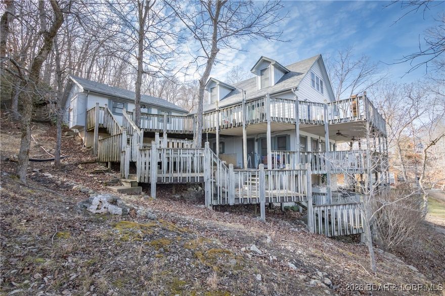 **HUGE PRICE REDUCTION** 110K Lower **Lakefront on "3" Acres **   **30' X 40' Building with 2 bays** One owner Custom Built Home - 4/3 Lakefront home sits on 80' of Lakefront in a large wide deep water cove. Includes over 3 acres with a **HUGE 30' X 40' SHOP** shop includes extra tall doors for RV parking/storage. Main level living home with a Newly remodeled Kitchen, includes custom cabinets, counter tops, lighting & more! Living room, Primary bedroom, and Full bath! Home includes multiple levels of living space. Lower level walkout includes Rec room, Bar, Bedroom and Bath. Top floor has 2 Bedrooms & a Full bathroom! Detached 2 car garage! Lot's of deck space for outside entertaining and to enjoy the lake. Nice private dock! Cove setting with a lot of privacy. Nightly Rentals ARE Allowed