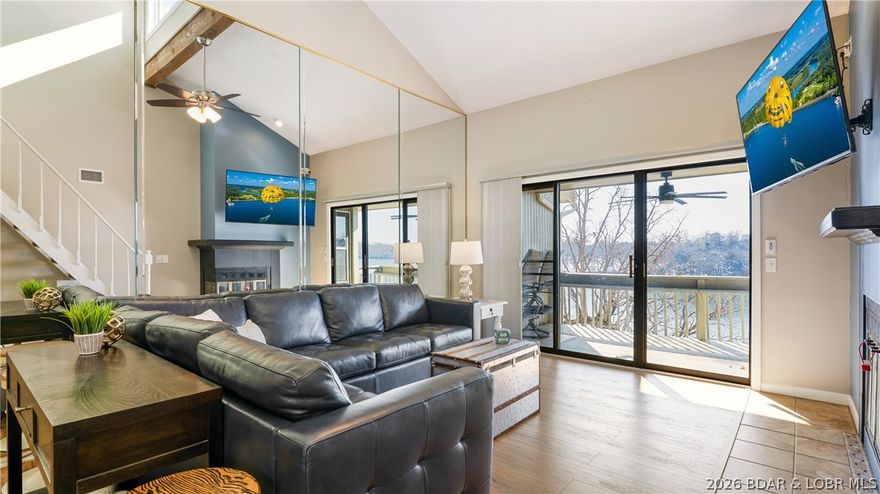 PRIME location by land AND water! Located right next to Margarittaville, this top-floor 3-bed / 2-bath condo at Pelican Bay condominiums, offers the complete package & complex also allows nightly rentals! Overlooking the main channel, you get an incredible view of the Osage 26MM, you get an opportunity to watch a multitude of boats cruise by from your private deck and enjoy stunning sunsets. This condo is move-in ready, FULLY furnished & includes a 12' x 36' boat slip (Dock H, Slip 4), which is just steps away & visible from your deck! This condo offers vaulted ceilings with a decorative beam, updated HVAC (2022), SS kitchen appliances, fresh paint throughout, mixture of tile and LVP flooring throughout, two spacious bedrooms on main level and a large 3rd bedroom upstairs. Upstairs loft sleeps four with a full bed and built-in twin bunks—perfect for family or guests.
The fireplace is a great focal point in your living room while not taking away any lake views. Unit is located across from the pool and clubhouse and has ample parking. Surrounded by many lakefront restaurant attractions, entertainment, grocery nearby & close to the hwy. This TURNKEY retreat is ready for you!