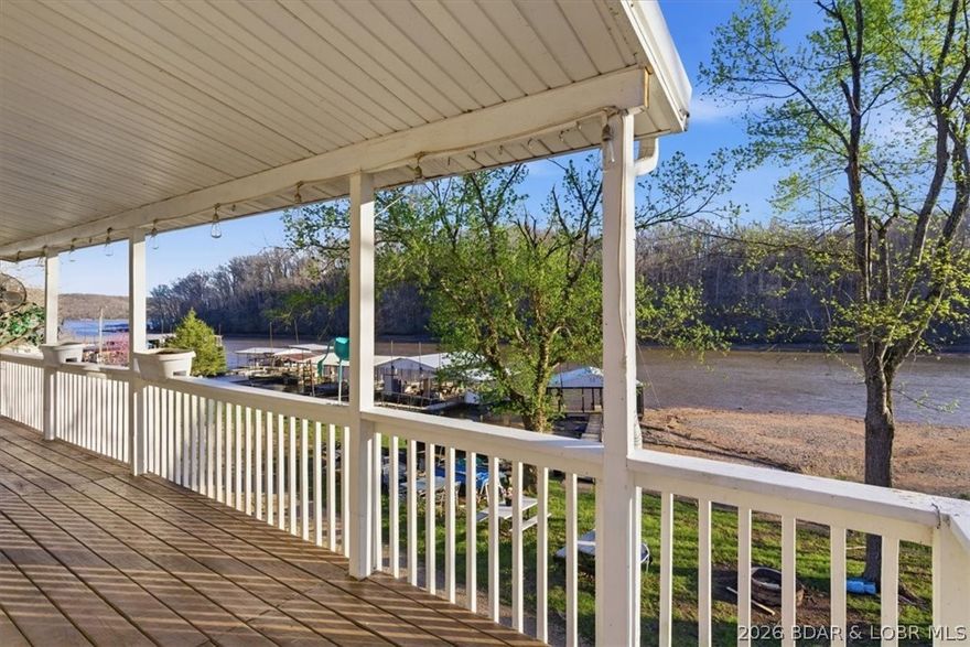 Lake life doesn’t have to break the bank—and this is your chance to get on the water with a dock already in place at a price point that’s hard to find! Tucked on the quieter side of the lake, this property offers a setting built for enjoying the outdoors, with great lake views, a partially covered deck, and a yard that actually gives you room to spread out. Being the last home in the cove means extra space to one side and a perfect setup for fire pit nights and yard games. A boat ramp just a few homes down makes getting on the water easy and convenient! The home is a 3 bed, 2 bath with a unique layout and is priced with condition in mind—offering the opportunity to make it your own over time. Crawlspace storage provides extra room for lake gear, and the 2-slip dock is already in place so you can start enjoying the lake right away. Nightly rentals are allowed, adding flexibility for future use!