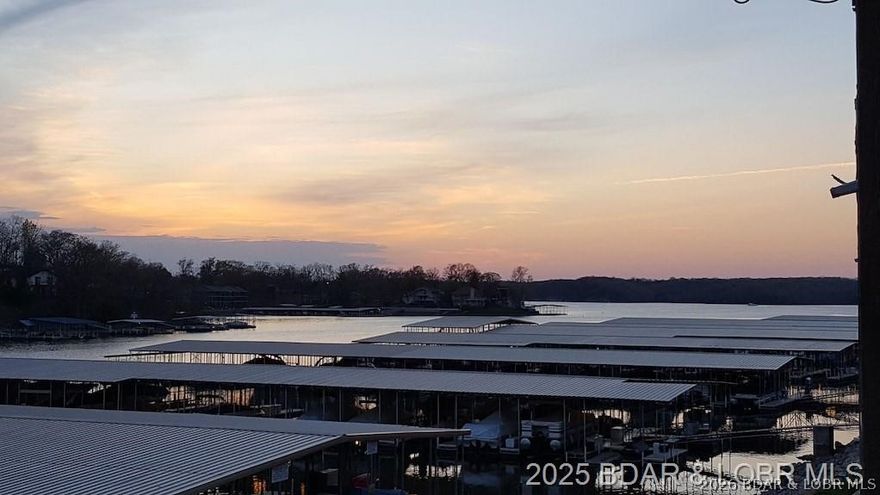 New Fantastic Price, Priced for Quick Sale. Location, Location, Location. Heart of Osage Beach, Parking lot level, bright and updated condo. New deck, new roof, great views of the beach area, very close to one of the two community pools, and your boat slip is right in front of your condo. Unbelievably convenient for anyone to enjoy the beach area, pool, or the docks to fish from or go on a boat ride. This beautiful condo is updated and very clean and maintained. Fantastic location by both land and water.