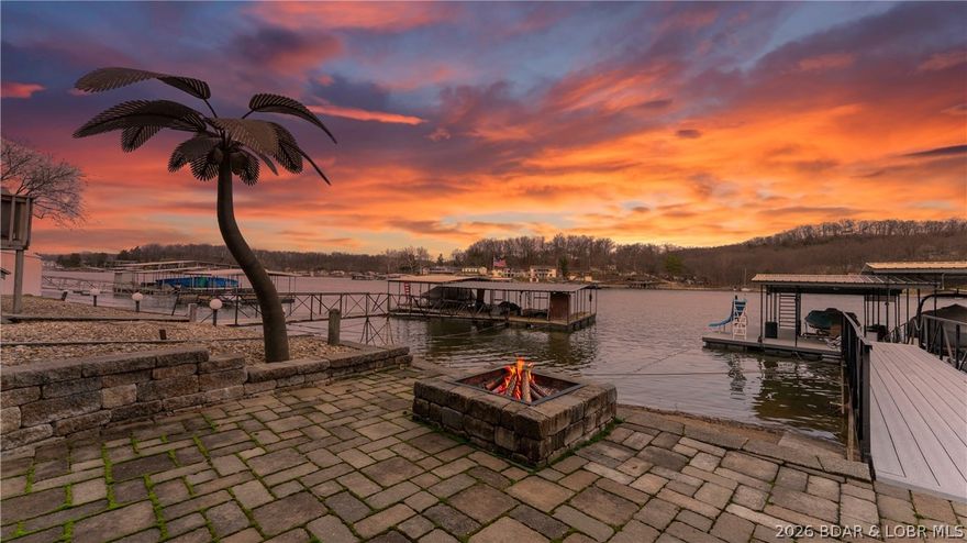 Experience the ultimate lake lifestyle at this lakefront home located at the 34 mile marker near Captain Ron's and many other waterfront restaurants. This turnkey residence offers true one level living. The main level features a primary suite along with a half bath, open kitchen and living area anchored by a cozy wood burning fireplace. A convenient laundry closet with stack washer and dryer is also located on this floor. Walk out from the living area to a massive covered deck featuring a custom outdoor kitchen overlooking the water. Property comes completely furnished with stylish furniture and furnishings. The waterfront includes a private 2 well dock with 10x24 and 10x20 slips that can be converted back to 10x28 and 10x24 sizes. Additional features include an oversized 2 car garage with built in sleeping quarters perfect for guests. If that isn't enough, it also comes with the second tier approximately 1.2 acres with a newer duplex, and large barn.  Income potential like this doesn't come along often.