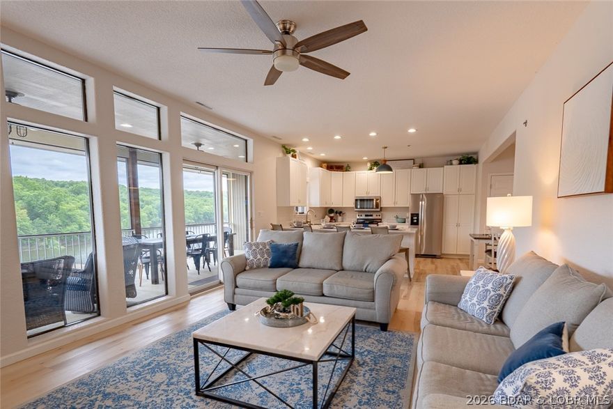Beautifully updated top floor end unit at Lazy Days in Osage Beach with a 10x24 boat slip, lift, golf cart garage, and outstanding amenities! This spacious 3 bedroom, 2.5 bath condo features an open layout with 9 ft ceilings, stylish finishes, abundant natural light, and a warm, inviting feel. The oversized kitchen offers extensive cabinet space, generous countertops, pantry storage, and seamless flow into the dining and living areas, making it ideal for entertaining and hosting guests at the lake. One of the standout features is the large screened deck where you can relax and enjoy peaceful cove and state park views. Located just steps from  community pools, Lazy Days also offers a lakeside boardwalk, wet steps on the docks for swimming, no wake cove, boat ramp, trailer parking, fish cleaning stations, clubhouse, playground, dog park, large lakeside grilling pavilion, seasonal security, and beautifully maintained grounds. Nightly rentals are allowed, making this an excellent investment opportunity or personal lake retreat close to waterfront dining, shopping, golf, and entertainment. Being sold furnished and ready to enjoy!  Lazy days Complex Qualifies for Conventional Financing.