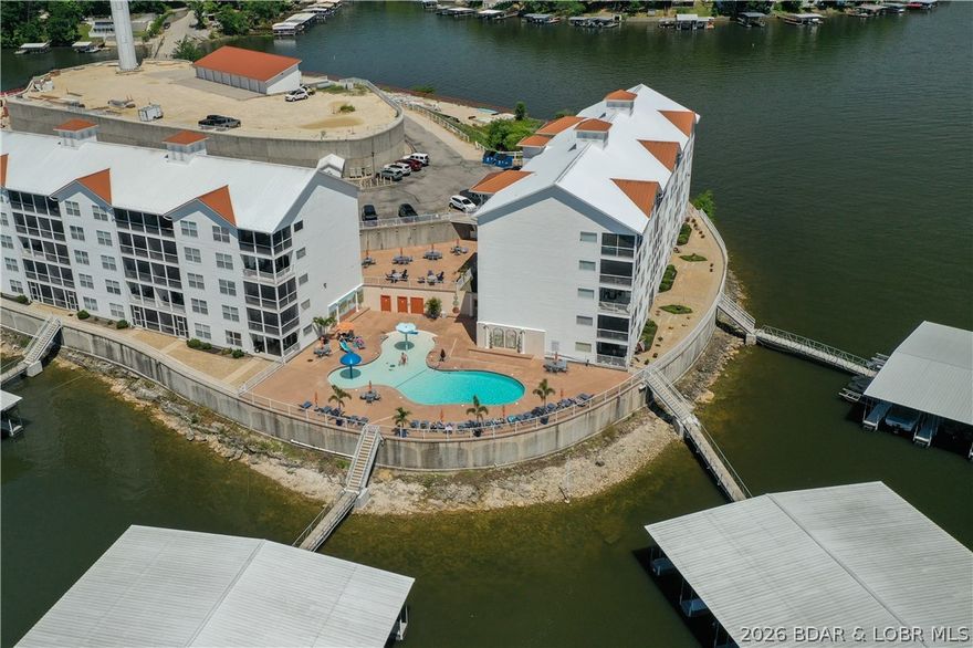 Location, views, and value—this top floor, end-unit condo at Isla Del Sol delivers all three. This unique complex is surrounded by water and accessed by a causeway, creating a true island-like setting with some of the best panoramic views you’ll find at Lake of the Ozarks.  This 3 bedroom, 2 bath condo offers 1,447 sq ft and is one of the most desirable layouts in the complex. Being a top floor unit, you’ll enjoy vaulted ceilings that create a spacious feel and maximize the incredible lake views. As an end unit, the condo features a more open deck area and additional natural light—two features buyers consistently prefer. The unit comes fully furnished and includes a 12x32 boat slip, making it ready for immediate enjoyment on the water. Located at the 4 Mile Marker, you’re just minutes from the Bagnell Dam Strip, placing dining, shopping, and entertainment close by.  For the size, boat slip, furnishings, and unbeatable views, this property is priced aggressively compared to similar condos at the lake. If you’ve been looking for a way to get a lot of condo and a lot of view for your money, this is a property you need to see.  Could also make a great rental property!