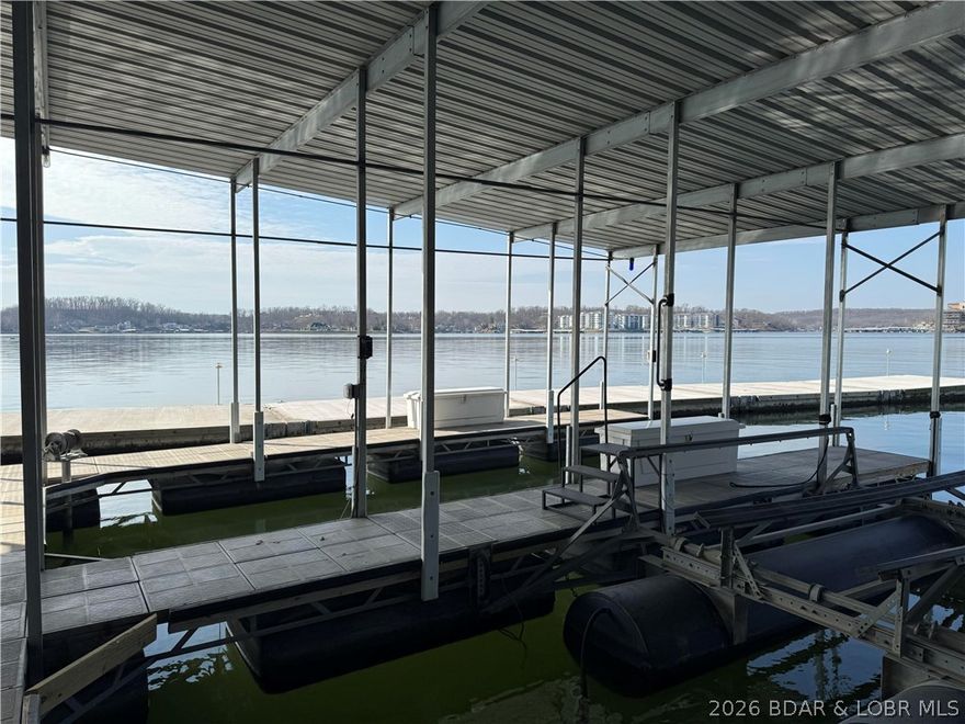 Representing an opportunities to construct a dream home within on of the Lake's premier subdivision, this property includes a 12x32 boat slip at the community dock, which features a newly constructed breakwater, providing convenient access to a range of lake activities. Right under an acre this 2nd tier lot is gentle on the road side, but goes to moderate for a wonderful opportunity for great lake views! Beacon Pointe stands as the premier housing subdivision, offering waterfront and lake-access residences, community docks with golf cart paths, a swimming pool, and a clubhouse. Situated only minutes from Highway 54, residents enjoy convenient access to shopping, dining, and entertainment venues. Located at the 2-mile marker, the property also grants access to tranquil waters suitable for boating, fishing, tubing, and skiing, as well as several prominent waterfront restaurants. This well-established, sought-after location presents an excellent investment opportunity for developers and American Dream seekers.