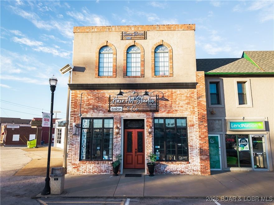 Owners are relocating! This incredible investment opportunity you’ve been waiting for has officially hit the market! Located in the high-traffic & highly sought-after Camdenton Square, this property offers unmatched year-round visibility in a prime location. Currently operating as a successful & well-known hair studio/spa/and boutique- the building proves to be the perfect business opportunity for individuals ready to step into ownership or an investor seeking a proven space. The interior is move-in ready, tastefully finished, with an impressive open spacious floor plan. An operating elevator leads to an upper level to be used as additional office space, income-producing rental units, or even private residential living. An unfinished basement provides ample room for storage or to expand & customize as needed. Whether you’re looking to grow your business or expand your investment portfolio, this property delivers location, flexibility, visibility and endless opportunities. Large maintenance items such as the Roof and HVAC units have been replaced recently. Make your move and secure a standout space in one of Lake's most popular area of growth & Camdenton's prime business district.