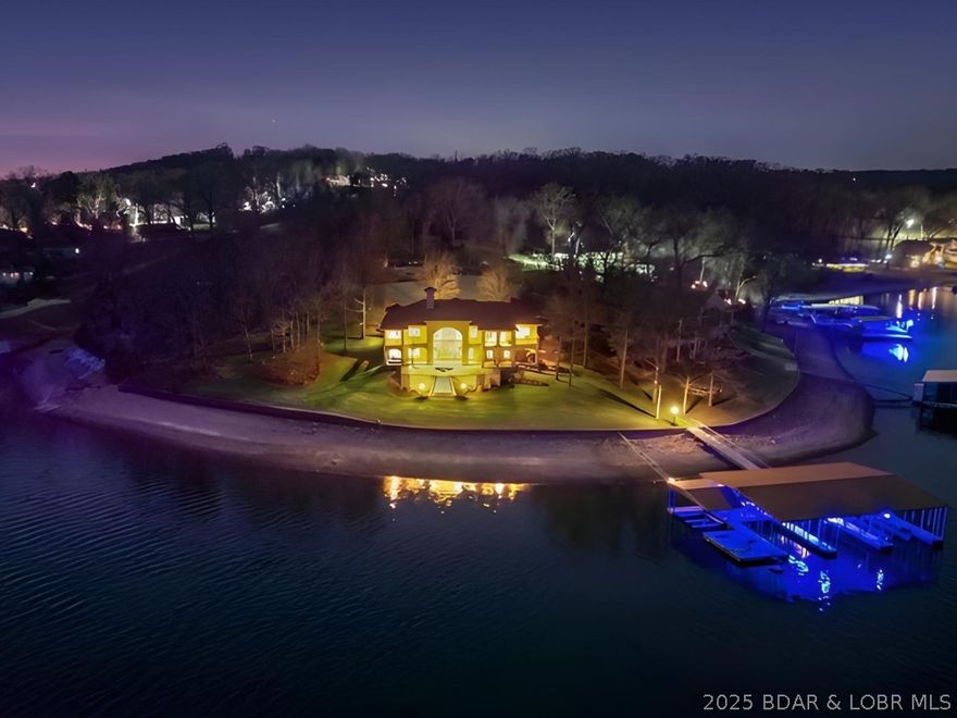 32 Quiet Waters sits on over one acre with 251 feet of lakefront, positioned on one of the flattest lots you’ll find at the Lake of the Ozarks & offering unmatched views of the Four Corners. Recently remodeled in 2024, this turnkey lakefront retreat showcases quality throughout and features 8 bedrooms (including 2 non-conforming) and 6 full bathrooms with over 6000+ SF of living space—providing ample space to host and entertain large groups who may never want to leave. The walk-out lower level opens directly to your private in-ground pool, surrounded by outdoor entertaining space, creating the perfect setting to enjoy lake life to the fullest. By water, this property truly sits at the crossroads of the lake, allowing you to easily access all the best the Lake has to offer. The well-built concrete dock, featuring four slips, is conveniently accessed with just four steps from the home. The lower level is an entertainer’s dream, complete with a custom game room, full kitchen, & spacious family room. This is a rare opportunity to own a turnkey lakefront home built for fun, comfort, and unforgettable memories—on a lot that’s as flat as they come.