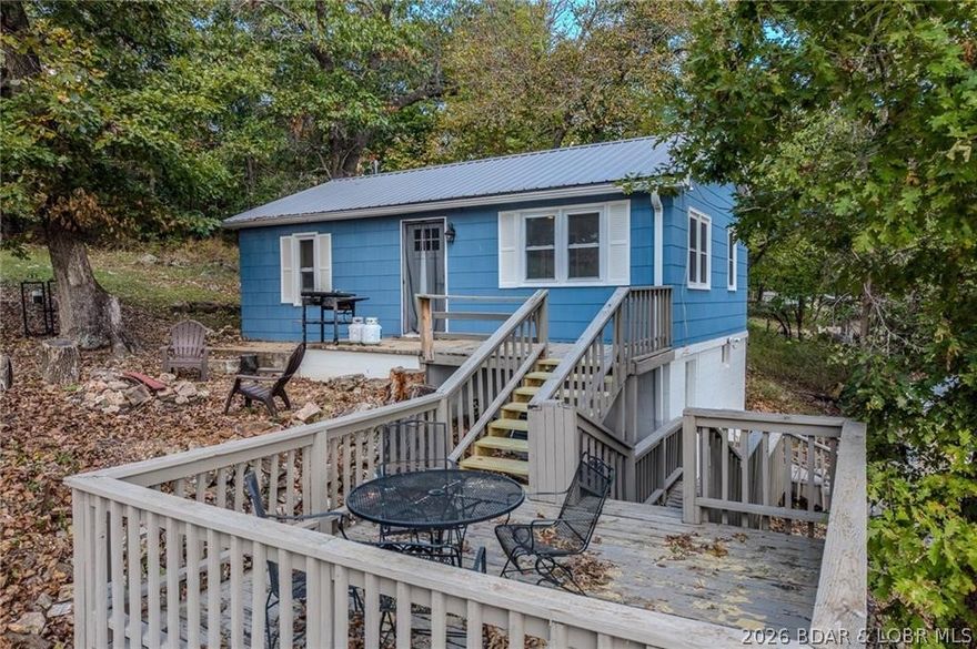Adorable and fully renovated lake home on the 77-mile marker of Lake of the Ozarks! This charming 2-bedroom, 1-bath property has been completely updated inside and out, featuring a stylish kitchen with all appliances included, fresh paint, new fixtures, and modern finishes throughout. Enjoy your own private dock with a 2-well slip perfect for easy lake access and entertaining. The home also offers a large detached two-car outbuilding, great for storage or lake toys. Currently used as a vacation rental, this home sits right next door to another available property an incredible opportunity to own two side-by-side lake homes for family, friends, or an investment compound. Located on nearly year-round water with a convenient commute from Kansas City, this is the lake life you’ve been waiting for!