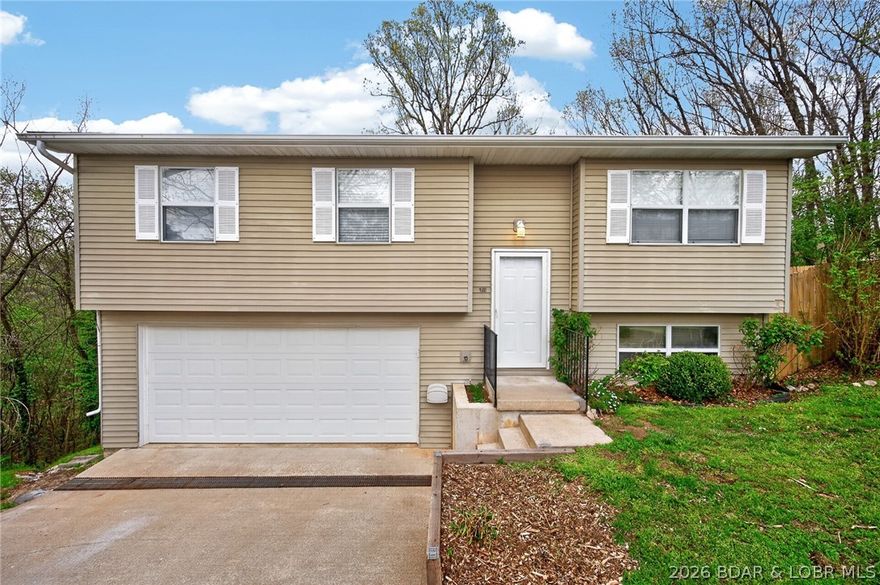 Feel right at home in this well-maintained 4-bedroom, 1.5-bath split-level (easily convertible to 2 full baths) nestled in the highly desirable Seven Trails West subdivision in Camdenton. The main level living flows beautifully for everyday living and entertaining. The partially finished basement offers fantastic flexibility—perfect for a bedroom, home office, or gym. A two-car garage adds convenient parking and valuable storage. Step out onto the deck and take in the large, fully fenced backyard that backs to tranquil forest, giving you privacy and beautiful natural views. Located at the end of a quiet cul-de-sac, this versatile home offers comfort, space, and serenity at a very reasonable price. Don’t miss out—schedule your showing today and make this wonderful split-level yours!