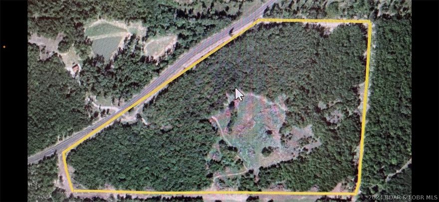 Great homesite, gentleman's farm or private hunting estate with 1761' of Highway 42 frontage. Easy off-road entry with beautiful Gated Cedar Post Monument Entrance and 52.31+/- rolling acres with ATV paths cleared for pleasure and hunting with lots of wildlife; deer, turkey, plus nice food plat areas, partially cleared w/creek that runs through it. Fully Surveyed, timber, and  blacktop entrance off 42. Just a few miles to the State Park Boat Launch & Lee Fine Airport. 12 miles to the best shopping, dining, and entertainment in Osage Beach and Lake Ozark.