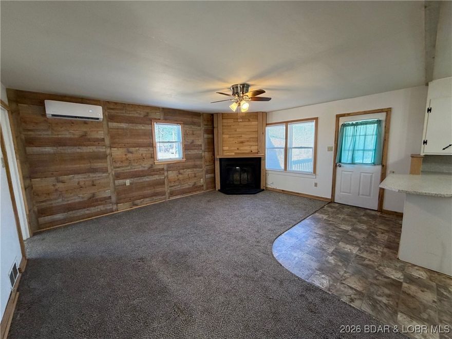 Cute as a button! This cozy cabin is perfectly positioned on a generous corner lot, offering extra space and charm. Early morning coffee on the adorable covered front porch &  host gatherings on the spacious entertaining deck, all set within the quaint and charming subdivision of Paradise Point Beach. Many updates include-new roof (9/25), mini split (23), new 36x24 Carport (24), new water heater (23) & retaining wall. The seller previously utilized the laundry room as an additional sleeping space (2nd bdrm), offering flexible use depending on your needs. Just a short distance away, you’ll find lake access, a beach area, & a boat ramp. This home offers a true weekend-getaway feel & is ready for endless summer days & unforgettable nights. With plenty of parking, there’s room to invite family, friends, & guests for easy, fun-filled events. Oversized detached 24x28 shop/garage w/concrete floors offers plenty of room for tinkering, for your vehicles/boat & all your lake essentials. AN IDEAL GETAWAY FOR FISHING ENTHUSIASTS! Full of charm & warmth, this adorable cabin is waiting for its new owners to step in, settle down, & enjoy the simple pleasures of a weekend retreat or fulltime home.