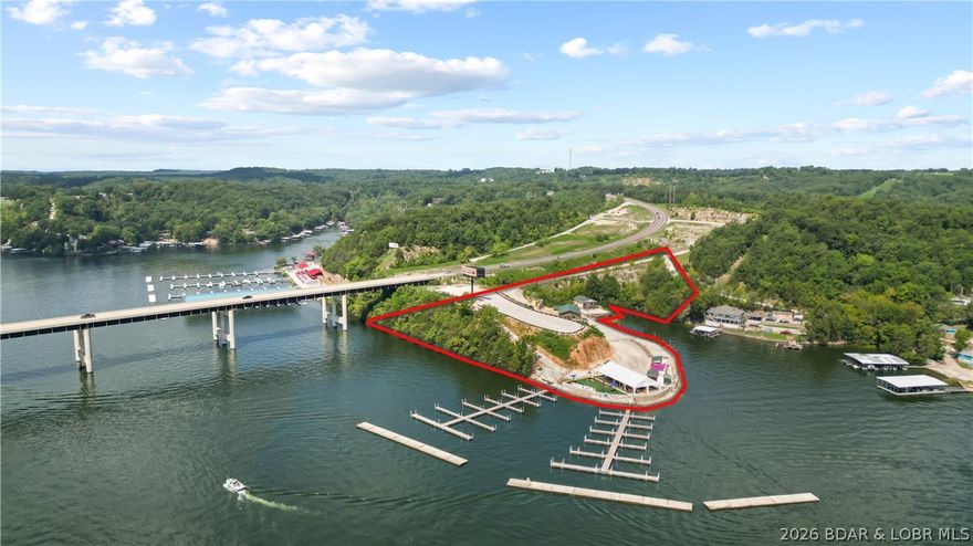 Calling on Investors!!! Take a look at this 4+ acre Blank Canvas with 1000 ft of prime Lake of the Ozarks
shoreline with 44 Slips and room for two more docks. A once-in-a-lifetime chance to acquire a commercial
property on the coveted 2mm of the Big Niangua. This remarkable property presents endless possibilities – from
a lakefront restaurant to a wedding venue or an event center with unmatched highway and water visibility that
ensures your venture will thrive. Additionally a thoughtfully designed 2700 sq ft building, perfectly tailored for
offices and meeting spaces. Adding to the allure, a remodeled 9 bed, 4 bath 1776 SF lakefront home is included,
enhancing the value & lifestyle appeal of this extraordinary package. Bask in the tranquility of lakefront living
while having your business venture just steps away. Don't miss this chance to own a slice of lakefront paradise
that's primed for success & ready to fulfill your grandest visions. Embark on a new chapter of ownership and
possibility – schedule your showing today!