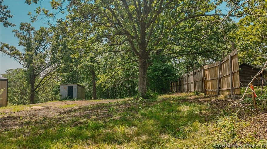 Need a little room to breathe and a place where you can actually "do stuff" without a permit, a prayer, and a neighborhood meeting? This 1.26-acre parcel just outside the city limits of Versailles, MO, is calling your name. The land is already cleared and ready to roll—no machetes, bush hogs, or weekend warrior brush battles needed. Less than half a mile of gravel gets you from the main road to your future kingdom, so you get the peace and quiet without needing a lifted truck and off-road tires. And yes, it comes with both a shop and a shed—perfect for tools, hobbies, or your secret stash of snacks you don’t want the kids to find. Want a home? Build one. Want a garden? Grow one. Want a place to raise chickens, goats, or the world's largest tomato? Go wild. Out here, the only limits are your imagination—and maybe your budget. So grab your boots and your blueprint. This land’s not going to dream itself into something awesome. Broker Owned