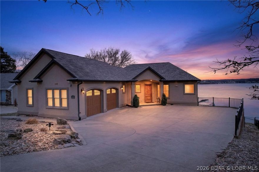 Experience unmatched lakefront living in this extraordinary retreat featuring breathtaking 360-degree views and rare, no-step access to the water. The gentle, walkable lot leads effortlessly to the shoreline, offering expansive main channel views in every direction.  A massive 2-well concrete dock is built for fun and function, complete with a breakwater, swim platform, slide, diving platform, with wet steps for easy water entry—perfect for enjoying true lake life. Inside, panoramic views fill nearly every room, including three ensuite bedrooms and multiple living spaces. With 5 bedrooms total—plus a spacious loft with twin/full bunks—there’s room for everyone. Sold turnkey with upscale furnishings and premium appliances, it’s ready to enjoy immediately. The walk-out lower level features a full second kitchen and bar, ideal for entertaining. Outdoor spaces include a screened deck and large patio overlooking a fenced yard. No HOA and located at the 19 MM off Hwy MM, just minutes from top dining, shopping, and entertainment. A rare opportunity to own a premier lakefront escape with unforgettable views and effortless access.