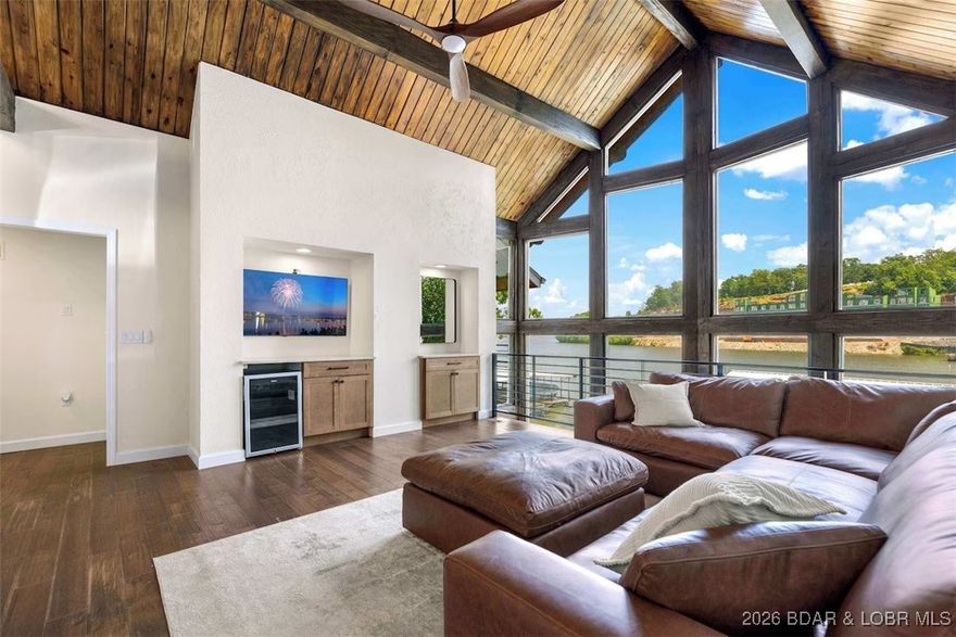 Incredible lakefront home on the 35 mile marker of Lake of the Ozarks! Located in a cove with main channel view, this place has tons of potential. Enjoy it as a full-time residence, personal getaway, or an investment property with nightly rentals! Gorgeous vaulted ceilings with tons of natural light facing due east. Two bedrooms and full bath are on the main level with a great family room space and the lower level features the kitchen with granite counters, stone fireplace, wood beams, ensuite with walk-in-closet, and more! Only a few steps to the lakeside, flat yard and year round water with over 20ft deep under the dock! Perfect for fishing and swimming. Just across the channel from Captain Ron’s, plus very close to The Cave, Bear Bottoms and numerous other places! High speed, fiber optic internet available, paved roads to the front door, parking for multiple vehicles, and only 2 hours to KC / 2.5 to STL.