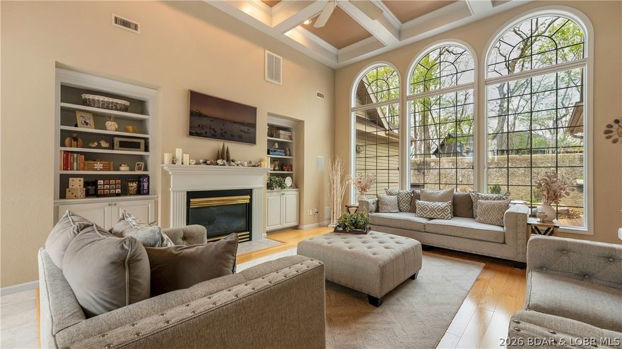 Upon entering this 4 bed nearly 2700sqft one level home, you'll first notice the massive 14ft ceilings and large window wall creating an impressive first impression. The living room creates a perfect entertainment area with lots of natural light from the 10ft tall window feature. You'll also find a gas fireplace and built in surround sound. The primary bedroom is spacious with attached en suite offering his and hers closets, his and hers vanities, and a jetted tub. On the primary suite side ther's also an office or 2nd bedroom with half bath. Off the kitchen is a breakfast nook and access to a 3 seasons room leading to the patio. Bedrooms 3 and 4 share a jack and jill bathroom. There is an ample sized laundry room and a bonus room great for an office, game, or hobby room. You'll find plenty of parking with the half circle drive and 3 car garage. Top it off that this home sits on a double lot adding privacy or the opportunity to add a pool! Being situated across the street from lakefront homes offers some seasonal views of the Lake. Four Seasons amenities included like the pickle ball courts and community pool just down the road. Don't miss out on this stunning Porto Cima home!