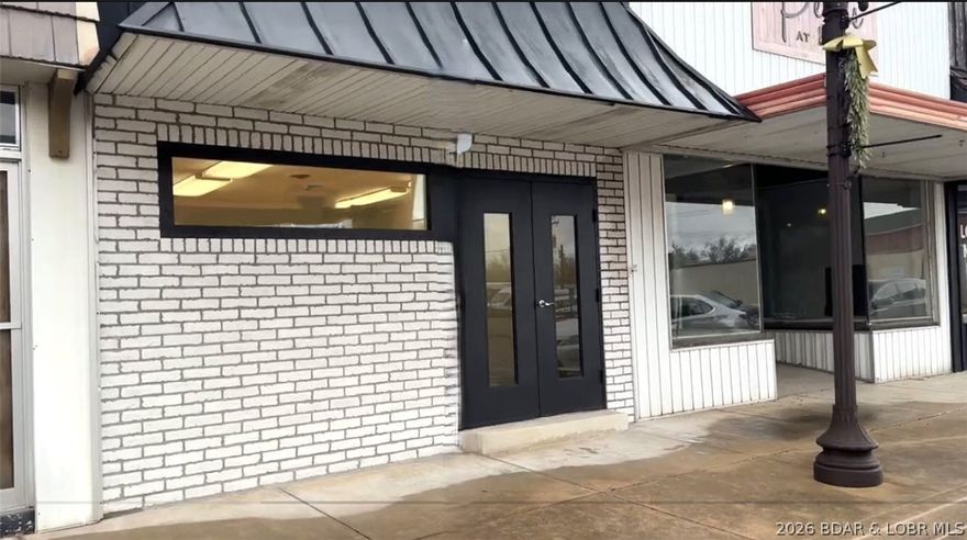 Prime your business for success at 11 S Maple in Eldon! This beautifully updated commercial building is truly move-in ready, offering a clean, modern space ideal for a wide range of business opportunities. Major improvements include:liquid rubber roof installed by Black & White Roofing (finished in white for enhanced energy efficiency), HVAC installed by Wyrick HVAC.  Fresh flooring, drywall and paint, an updated front window, and upgraded restroom fixtures including a sink and toilet. The exterior has an attractive real brick façade, NS routine pest service has kept the property well-maintained. Constructed with durability in mind, the building features a solid slab foundation, cinder block walls, and a steel frame structure. The functional layout includes a welcoming lobby, two main offices, a storage closet, a bathroom, a spacious third back office, and an additional rear storage room. A gravel parking area in the back adds convenience for staff and clients alike. Located in a growing community with strong employment opportunities, an excellent school system, and a welcoming atmosphere, this is an outstanding opportunity to establish or expand your business in a thriving market.