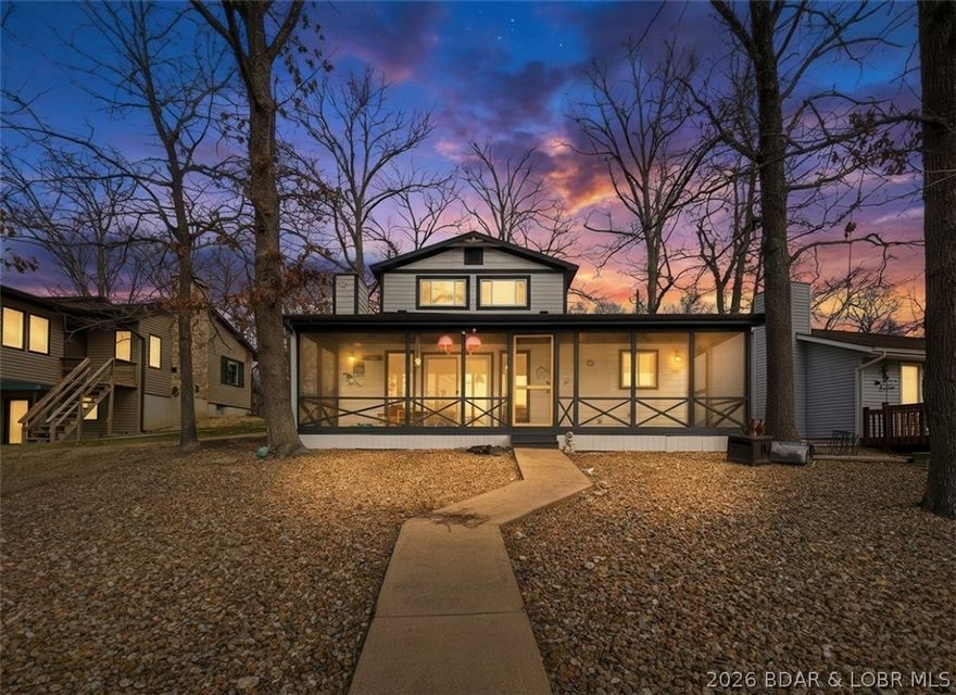 COVE LOCATION, MAIN CHANNEL VIEWS, & SUPER GENTLE LOT....ZERO STEPS TO THE DOCK!!! Completely renovated and expanded with major updates including garage addition, siding, flooring, kitchen, bathrooms, fixtures, paint, and HVAC in 2020, plus a new roof in 2024 — this home is truly move-in ready. Vaulted ceilings and an open-concept layout highlight incredible lake views from the main living areas and upstairs second living room / flex space. Not to mention the great outdoor living space, which is exactly what lake life is all about! From a spacious screened-in deck, lakeside fire pit, plus a huge front yard that is perfect for yard games and pets (or to build a guest house, shop building, etc.). The dock features 1 boat slip, 2 PWC slips, and a huge swim platform that has plenty of covered and uncovered space! The 44 mile marker all about the traditional lake day—swimming, fishing, coving out but still having waterfront restaurants like Big Dicks, Boondockz, Bear Bottoms, & more nearby! Don't forget about the NO hoa, flat driveway, 2-car garage, nightly rentals allowed, and high speed fiber internet through CoMo Connect.