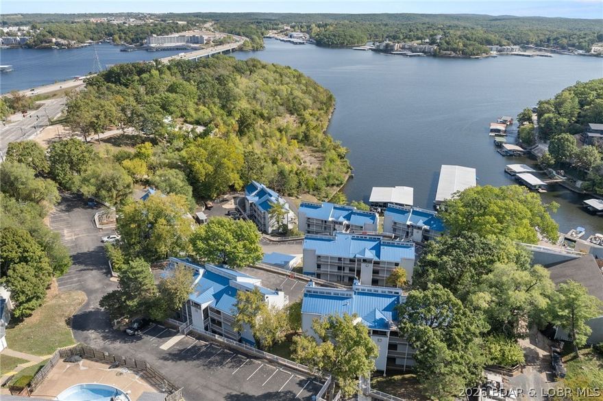 Stop searching and start living! Welcome to your move-in-ready sanctuary at Hawks Nest Lodge, perfectly positioned in the heart of Osage Beach at 1MM of the Glaize Arm. This isn't just a condo; it’s your front-row seat to the best of the Lake. This spacious 1BR/1BA walk-out level unit features a bright, open floor plan designed for the modern lake lifestyle. Updated with LVP flooring and sleek stainless-steel appliances, the interior exudes a fresh, contemporary vibe. Cozy by the fireplace on chilly evenings or enjoy the ultimate convenience of in-unit laundry and a walk-in pantry. Step outside to your large private deck to soak in beautiful lake views. The community perks are truly elite: Prime Lake Access: Cove-protected waters, a secured dock with a golf cart path, and a rare swim platform; Clubhouse: A social hub featuring a bar, game tables, ice machine, and extra laundry; Prime Location: Seconds away from top-tier dining, shopping, and vibrant marinas. Whether you’re hunting for a high-potential rental investment, a weekend getaway, or a full-time residence, this affordably priced gem is the one. Schedule your tour today—the lake is calling!