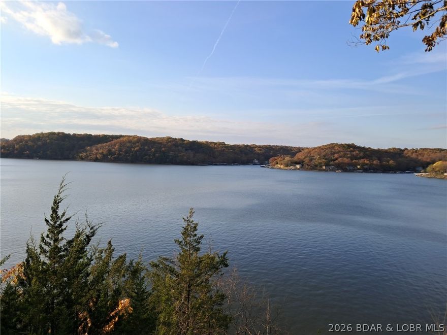 Wake up each day to breathtaking panoramic lake views from this bluff-top property offering one of the most dramatic vantage points on the water. The existing home is a fixer or a possible tear-down, giving you the rare chance to design and build exactly what you want in a setting that’s impossible to replicate. Perfectly perched above the shoreline, the lot delivers elevated, unobstructed vistas and year-round scenery, from peaceful sunrises to stunning sunsets. Whether you envision a modern full-time residence or a custom vacation retreat, this property provides the ideal canvas. Create your dream home and enjoy some of the most spectacular views on the lake.