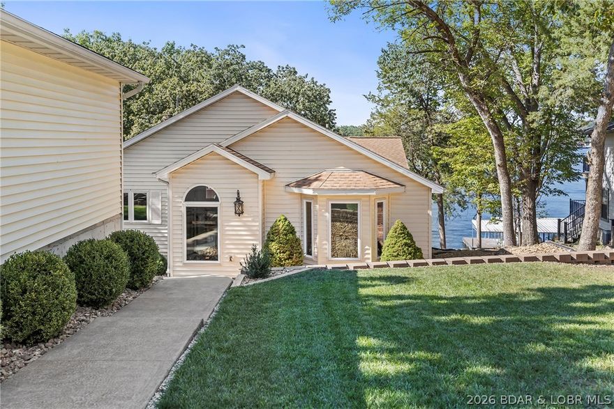 Newer 2 well concrete dock with swim platform, a gentle lot and an unbeatable view! The open floor plan features living on each level(there is a kitchenette off the lower level family room). The kitchen features hardwood floors, custom cabinets, granite countertops and a wonderful 13' island. There's a formal dining room off the kitchen which could serve as a great home office. The detached 2 car garage has a 15x24 work shop perfect for crafts or woodworking or just extra storage. With over 3400 s.f., there is room for everybody to have their own space. Great location by land or water(Mill Creek Cove) close to Indian Rock Golf course, movie theater and restarants. This would make a great vacation rental!