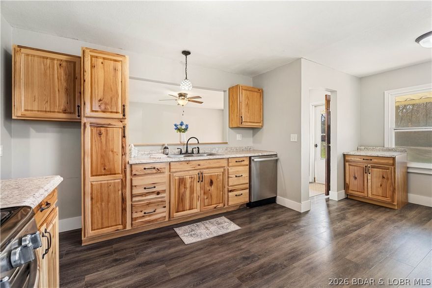 Charming, move-in ready, one level living perfectly located just outside Eldon city limits! This 3 bed, 1 bath home sits on a full, wood acre on a quiet dead-end road, offering both privacy and convenience—plus walking distance to Eldon South & Upper Elementary Schools. The beautifully restored hardwood floors and a long list of updates, including a new roof (2023), new central air (2023), new baseboards throughout and fresh paint that gives the entire home a clean, modern feel. The fully renovated bathroom features all-new plumbing, flooring, electrical, and vanity—done right from top to bottom. Low maintenance LVP flooring enhances rustic kitchen w/ new hardware & garbage disposal. Step outside to a deck just off the kitchen, complete with solar lighting, leading down to a spacious fenced yard. Whether you need space for pets, play, or entertaining, you’ll love the included dog kennel, room for a playground or fire pit area, and a detached garden shed for extra storage. Affordable, updated & full of charm—this property is a perfect fit for first-time homebuyers, downsizers or investors looking to add a solid asset to their portfolio.