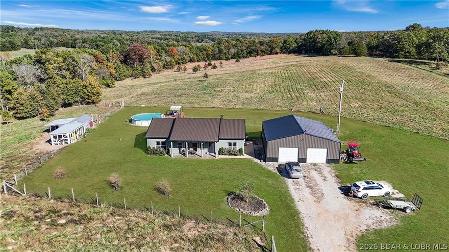 Welcome to your peaceful home in the country! Only 28 minutes to Osage Beach but feels like you're far, far away. This custom-built home on 40 acres plus the 36 x 40 detached 3 car garage with 3 garage doors and a butcher shop including a walk-in cooler is just the beginning! Plenty of room to spread out and have cattle, chickens, goats, horses, lots of wildlife, deer (lots of deer) and turkey. You will love the attention to detail on the construction of this home! Check out open concept kitchen with walk in pantry, great room with fireplace, dining room and master suite with fireplace. Fall in love with the unique wood accents. Maybe you'd like to have a farm and raise all your own vegetables! Enjoy the covered patio and outdoor kitchen or take a dip in the above ground pool. Land is fully fenced with some cross fencing and a creek. Chicken coop is also custom with attached chicken run. You can work in town and escape to the country in just minutes. If you are looking for peace and serenity, this is it!