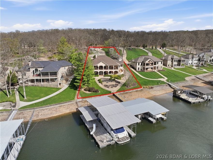 Luxury lake living in prestigious Porto Cima.  This exceptional 6-bedroom home and 4.5 bathrooms offers approximately 4,800 square feet of beautifully designed living space, perfectly positioned on 128+ feet of lakefront. Designed for both comfort and entertaining, the home features a sprawling open floor plan, main-level living. Two full kitchens provide added convenience?ideal for hosting guests.  Step outside to take in breathtaking lake views from two expansive deck areas, complete with a custom BBQ station. The professionally landscaped grounds lead to a gentle walk to the water, where you?ll find a 4-well dock with PWC lifts.  This gorgeous home comes completely turnkey including two boats and PWCs. Lake life starts here!
