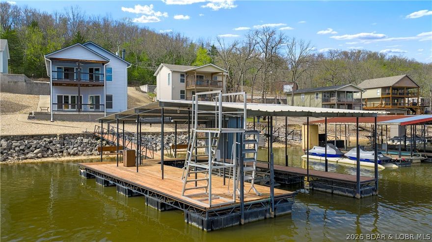 Well-maintained lakefront home located at the 38 Mile Marker of the Osage Arm at Lake of the Ozarks. This 3,005 sq ft, two-story property offers a functional layout for full-time living or a vacation retreat. The main level features 2 bedrooms, including an oversized master suite, 1.5 bathrooms, a kitchen, dining area, family room, and main-level laundry. Enjoy the large covered deck with lake views. The lower level includes 2 bedrooms and 2 full bathrooms, including one ensuite, a spacious family room, and an oversized bar area with potential for a second kitchen, along with walk-out access to a covered patio.

The home sits in a large protected cove offering calm water, ideal for enjoying time on the dock. The exterior features minimal steps to the dock (approximately one step) and a detached 2-car garage. The private dock includes a 12x36 slip, swim platform, and electrical that has passed inspection. A pre-listing inspection has been completed with nearly all items addressed. This property offers an ideal setup for multi-family use, entertaining, or rental potential, with convenient access by water and road.