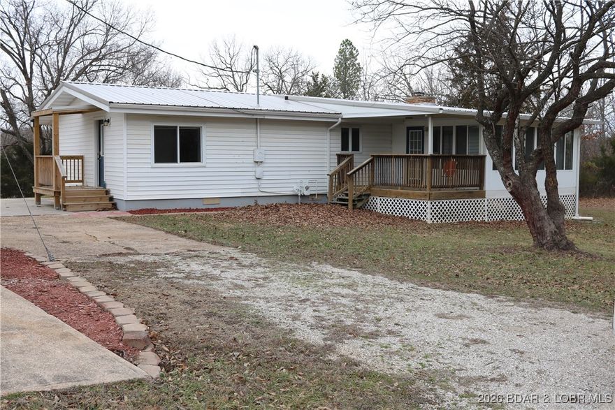 Really nice country setting with access to Lake of the Ozarks.  Move-IN ready with all the fresh updates including new paint, newer roof, new HVAC, new plumbing, bathroom, floors redone.   This home sits on a level 1.5 acres with views all the way around.  Room for a garden.  Out standing 30 x 24 garage and concrete patio.  There is a all season sun room attached to the home also.  Wood burning fireplace for those cozy winter nights.  Located within 10 minutes of Laurie or Gravois Mills and a short distance to Lake Burger.   This is an inexpensive way to call this home YOURS.  Give me a call and I would love to show it to YOU.