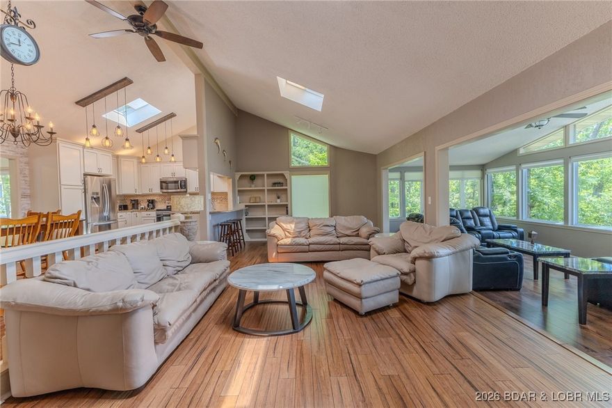 Located in the iconic Tan Tar A Estates, just steps from Margaritaville, this home truly has it all. The spacious open floor plan features two dining areas, two living spaces, and a cozy wood-burning fireplace—ideal for entertaining or everyday living. With only two steps to enter and a main-level primary suite, comfort and accessibility are front and center. The carport offers excellent protection and generous storage, with the option to easily convert it into a fully enclosed 2 car garage. Enjoy beautiful views of the main channel, with boat slip options available for lease. Completely updated throughout, the home showcases wood floors, newer cabinetry, and stone countertops. The lower level provides three additional bedrooms, three full bathrooms, and a spacious laundry room. Centrally located by both land and water, you’ll have easy access to all of the area’s top attractions. Resort amenities within one mile include a swim-up bar, tiki bar, family pool, lakeside bar and grill, two community pools, playground, and FREE golf. This golf-cart community is truly unmatched at the lake. Ideal as a full-time residence, vacation getaway, or proven income-producing property. Call today