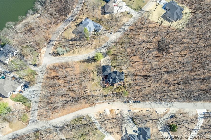 Phenomenal, oversized building lot in Porto Cima in a neighborhood of luxury homes..  Gentle terrain with lake view and a mated pair of Eagles have a nest that can be viewed from the property. Amenities include pools, clubhouses, social clubs, boat launch facilities, golf, tennis, pickball, playgrounds & more.  Public Water and Sewer District