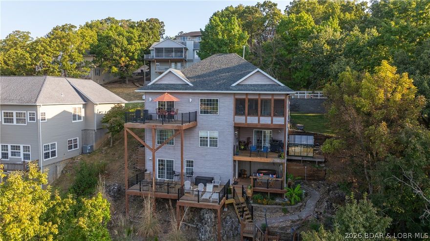 Welcome to Minnow Brook Subdivision, nestled on the Big Niangua & only a few minutes from restaurants,
shopping, schools and 2 excellent golf courses as well as Ha Ha Tonka State Park. This 4 bedroom, 3 bathroom
house sits regally on a bluff & has panoramic views that seem to go on forever. With the recently remodeled
decks on each of the three levels of the house, along with a hot tub, two-person sauna, and a screened in three
seasons room, there is plenty of time to connect with nature or soak up some sun before going down to your
new concrete dock that has a 16x40 slip, two PWC shoreports & 12'X20' swim platform. Inside the house, more
views of the Lake can be seen through almost every window & the main level primary en suite (with newly
remodeled bathroom) provides privacy from the remaining 3 bedrooms located on the middle floor. A family
room, a living room and a sitting room, one on each level, creates plenty of space for family or company to
never have to fight over what to watch on TV. There are so many fascinating aspects of this house, it's
definitely one to come see. Partially furnished and even the boat could be included for additional $$. Come
check it out!