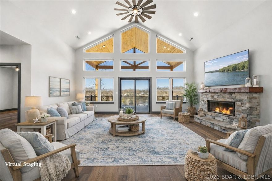 Experience lake living with sweeping views of the 5MM from this stunning 4 bed, 2.5 bath custom Amish-built home situated on a desirable 2nd-tier lot. Paved roads lead to the new development, Los Breezes, where buyers have the rare opportunity to get in on the ground floor of a new HOA offering community well water. Enter from the covered front porch with 8x8 posts through glass, double front door to soaring vaulted ceilings where wall-to-wall windows frame breathtaking water views. The open concept floorpan leads to a chef's Kitchen w/ solid Hickory wood cabinets, quartz countertops, black stainless appliances, large island & a spacious walk-in pantry. 
The living area features stone fireplace that flows seamlessly to a massive covered deck, perfect for entertaining friends & families while taking in the sounds of the water beyond. An oversized 2-car garage offers plenty of room for ATVs, golf carts, or motorcycles, while the mudroom with cabinets & bench keep coats and boots organized year-round. Quality craftsmanship shines throughout with Smart Siding, LVP flooring & 6 inch trim. New construction, lake views, and exceptional craftsmanship—this one delivers outstanding value.