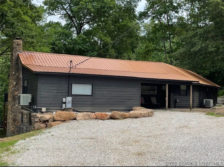 This beautifully renovated property offers the perfect blend of comfort, style, and unbeatable views at the Lake of the Ozarks. The primary home features 2 spacious bedrooms and 2 full bathrooms across 1,963 sq ft, designed with large, open living and entertaining areas that make hosting family and friends effortless. Step outside to a generous deck overlooking the water—ideal for morning coffee, evening sunsets, or weekend gatherings. With direct lakefront access and your own private dock, you’ll enjoy everything lake life has to offer right from your backyard. Situated on 1.63 acres and including two properties, this unique offering also features a fully renovated 400 sq ft guest house (1bed/1bath) and is perfect for visitors, rental income, or a private retreat.  Both homes were completely renovated in 2021.