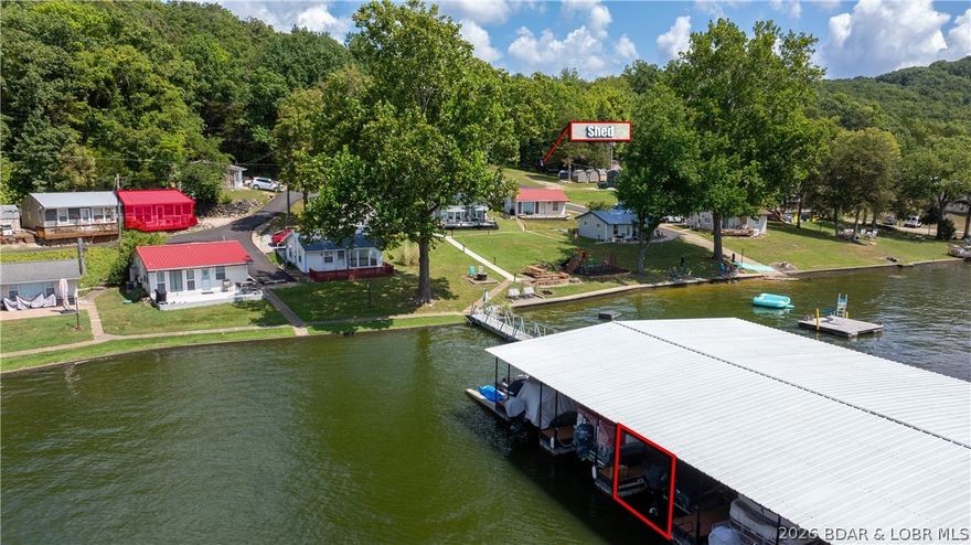 Lake views and easy lake living await! This 2-bedroom, 1-bath townhome offers 576 square feet and overlooks the 11 MM of the Big Niangua Arm at Lake of the Ozarks. The property includes a 10x24 boat slip with a Firstmate remote-controlled hoist, accommodating boats up to 27 feet and making launching and loading effortless. Community amenities include a sand beach, playground area, and a floating swim dock with waterslide—perfect for enjoying long summer days on the water. Several updates have already been completed, including new siding in 2021, upgraded 200-amp electrical service in 2019, and a newer front deck added in 2018. The metal roof was installed in 2005. The subdivision also installed brand-new asphalt on July 23, 2025, which has already been paid in full by the seller. A storage shed provides additional space for lake gear and outdoor equipment. Whether you're looking for a weekend retreat or a low-maintenance lake escape, this property offers a great opportunity to start enjoying Lake of the Ozarks.