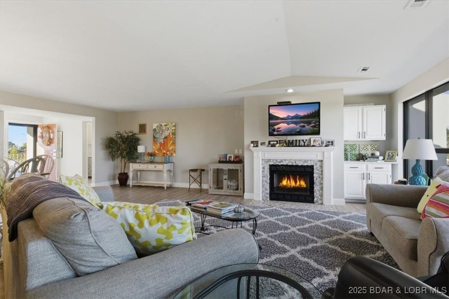 Enjoy the best of lake living in this beautifully remodeled lakeview condo at Lake of the Ozarks! Offering 2,036 sq ft of modern finishes, this 3-bedroom, 3-bath residence has been completely updated and move in ready. The open floor plan features luxury vinyl plank flooring throughout, a neutral palette, and a cozy fireplace in the living area—wonderful for relaxing or entertaining. The gorgeous kitchen showcases quartz countertops, subway tile backsplash, stainless steel appliances, and breakfast bar for gathering with family and friends. Each bedroom offers generous space, while the bathrooms have been tastefully updated with contemporary design elements. Take in views from your private balcony, or head down to your boat slip (including additional Jet Ski PWC slip) for a day on the water. This property includes an ideal layout for full-time living or a lake getaway. Located close to popular restaurants, shops, and all the entertainment that makes Lake of the Ozarks famous, this condo delivers the ultimate lake lifestyle.