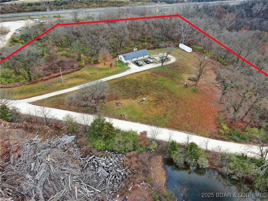 Beautifully updated 3,024 sq ft home on 4.9 acres just off Hwy 54. This 4-bed, 2.5-bath property features an open, spacious layout with multiple living areas. Large eat-in kitchen, vinyl flooring throughout, and remodeled baths. Home includes 3 wood-burning fireplaces and a partially finished walk-out basement offering additional living, storage, or hobby space. Exterior features include two large decks, a covered patio, vinyl siding, architectural-shingle roof, and a gravel driveway. Property is serviced by a private well and septic system. Acreage provides privacy, mature trees, and space for future outbuildings or recreational use. Convenient location minutes from Eldon and Lake of the Ozarks.  This is a must see!