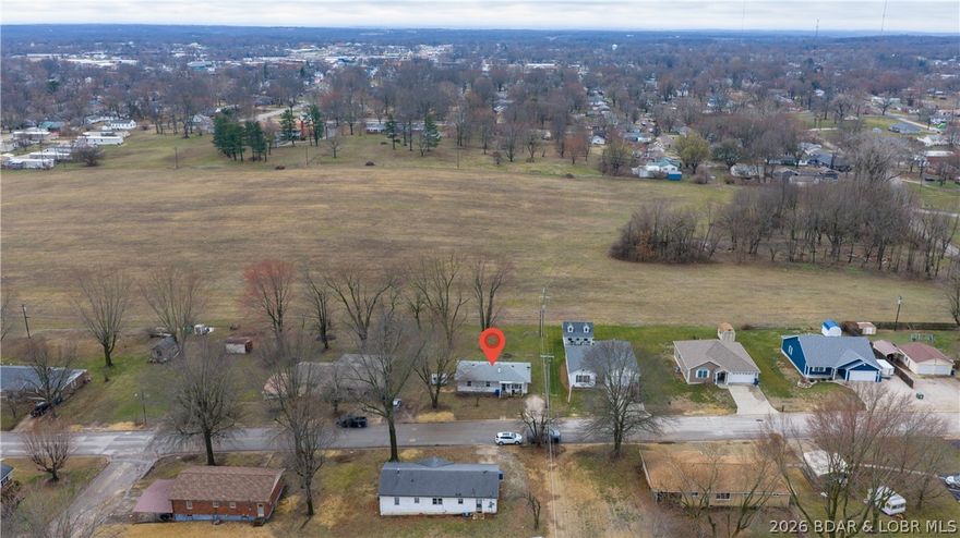 Affordable ranch-style home in Eldon offering convenient main level living! This 3 bedroom / 1.5 bath home sits on a FLAT lot with a spacious backyard that backs to large open acreage to give a nice private feel and peaceful views. The living room features laminate flooring with a shiplap electric fireplace, large mantle & built-in shelving as the focal point. Kitchen offers great cabinet space, small pantry, tile countertops & nice built in sitting area in the dining room. The primary bedroom includes an updated bathroom with new: shower insert, tile flooring, vanity and fixtures. A full unfinished basement offers excellent storage or the opportunity to finish for additional living space. Basement currently has an exterior door that used to be a garage door, could be converted back if desired. Exterior features vinyl siding with white brick accents and a covered front patio. Back deck is open to the flat back-yard and firepit area. If you're looking for an affordable home with room to expand, a great yard and peaceful setting, this Eldon home is a must see!