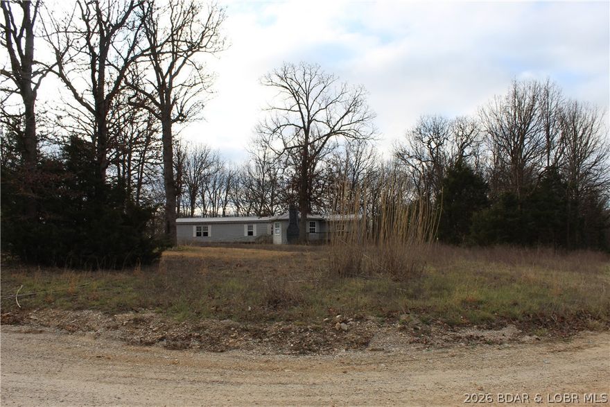 Discover the potential of this 5+ acre property located just over 6 miles south of Iberia, Missouri. With utilities already in place, a concrete slab for a 2-car garage, and a large storm shelter, much of the groundwork is already done—making this an excellent opportunity to build your dream home in the Ozarks. Enjoy the quiet, small-town charm of Iberia with convenient access to local shopping and dining, while still being just a 35-minute drive to Osage Beach, Missouri and all the recreation, entertainment, and amenities of the Lake of the Ozarks.
A 2004 4-bedroom, 2-bath manufactured home currently sits on the property and is being sold with no assigned value due to condition. However, for the right buyer with vision and ability, there may be potential for renovation or repurposing.
Whether you’re looking to build, invest, or create your own private retreat, this property offers a strong head start and plenty of possibilities.