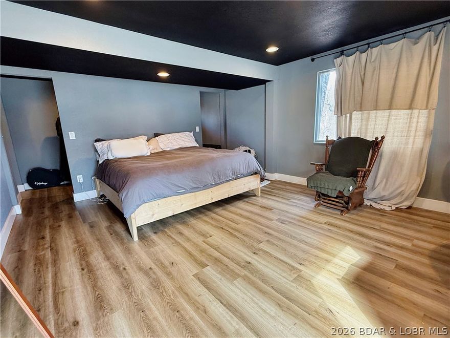 Beautifully updated home located in the heart of Osage Beach, situated on a desirable double lot offering extra space, privacy, and added potential. This 3 bedroom, 3 bathroom home features fresh paint and new flooring throughout, creating a bright, clean, and move-in ready feel. The lower level is dedicated to a spacious private primary suite, complete with a double vanity and relaxing soaking tub, providing a comfortable retreat away from the main living area. On the main level, the two bathrooms have been recently refreshed with painted vanities, adding even more modern appeal. The double lot provides additional room for outdoor enjoyment, future improvements, or simply extra breathing room rarely found in this area. Loads of updates, including a newer roof, make this property truly move in ready. Conveniently located near shopping, dining, entertainment, and Lake of the Ozarks amenities, this property offers a great combination of updates, space, and location in one of the lake area's most sought-after communities